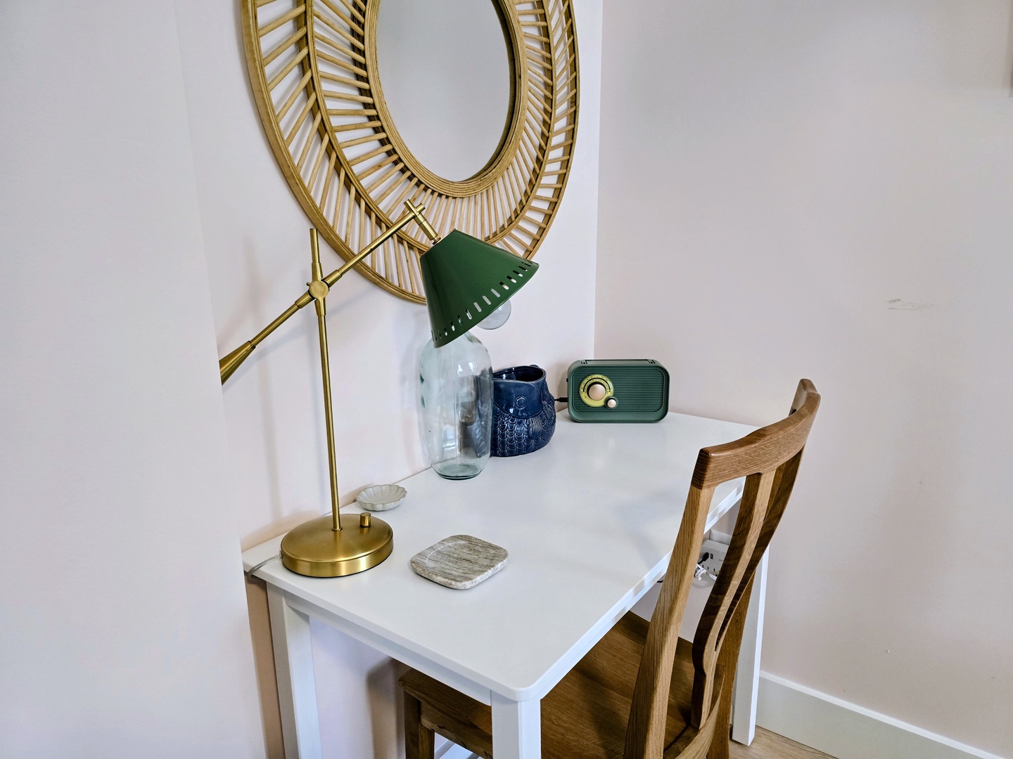 Your stylish workspace features a vintage radio, elegant gold mirror, and brass desk lamp for productive mornings.