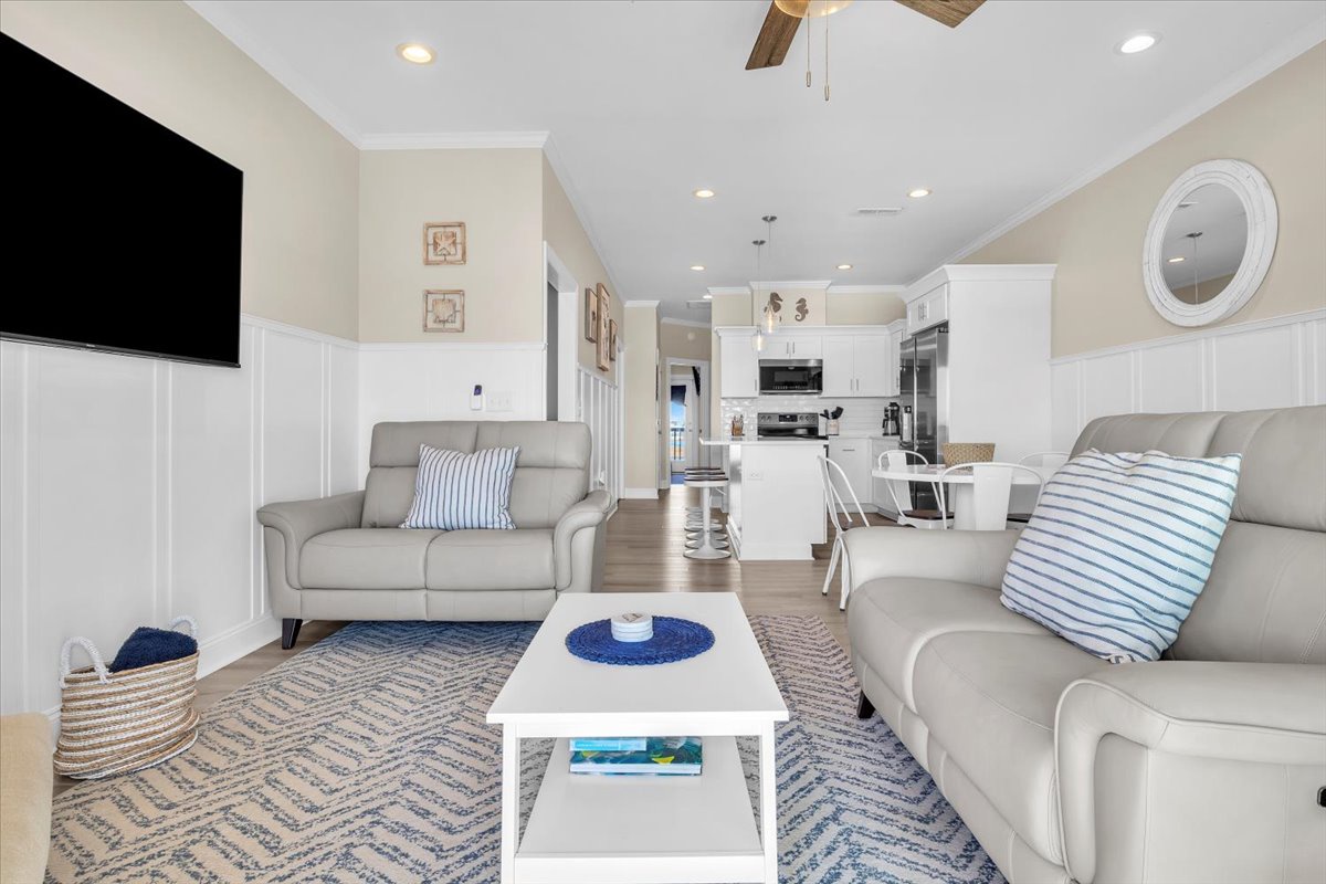 Relax in your spacious living area with comfortable seating, modern amenities, and an open kitchen perfect for preparing meals together.