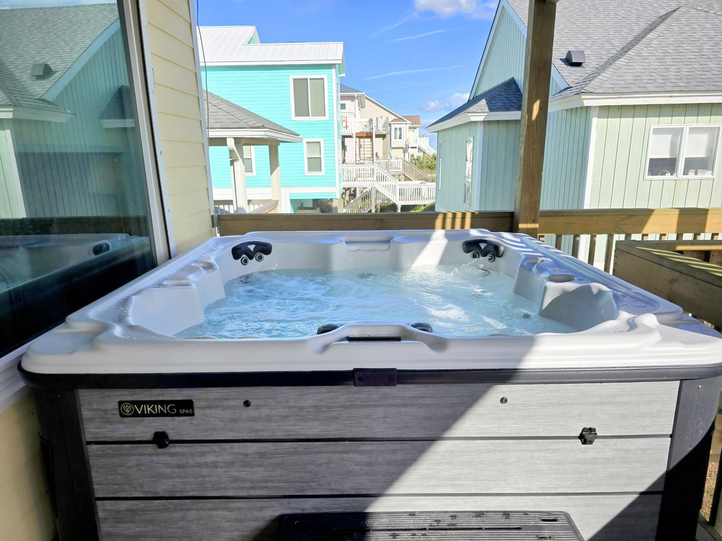 Soak in your private hot tub while taking in charming coastal cottage views—pure relaxation awaits.
