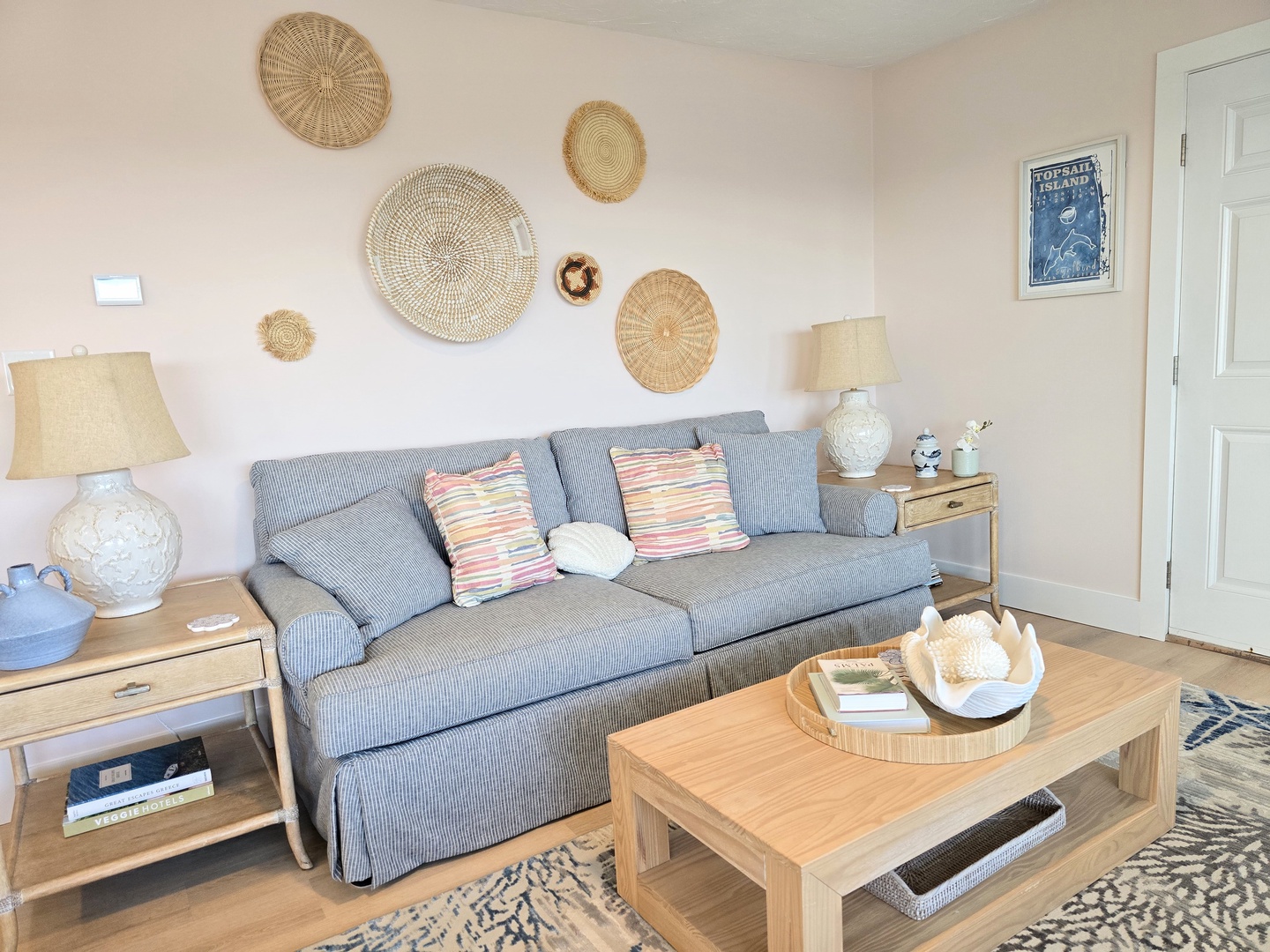 Your coastal-inspired living room invites relaxation with comfortable seating and charming nautical touches throughout.