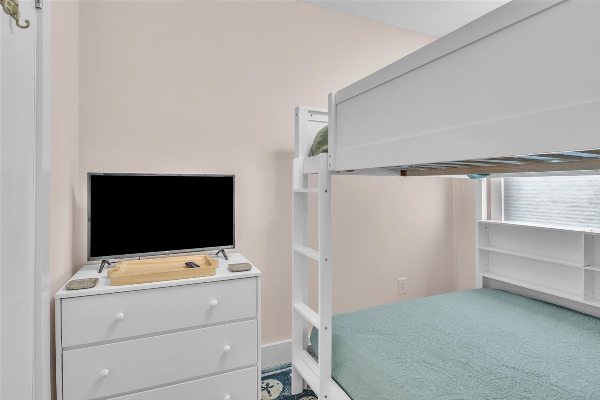 Your kids will love this cozy bunk bed room with entertainment center and plenty of storage for their belongings.