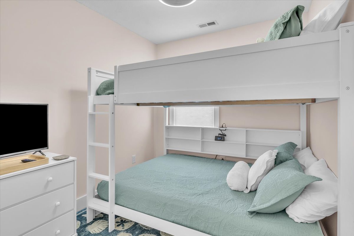 Your cozy bunk bed retreat features soft mint linens and convenient storage, perfect for families or groups sharing memorable stays.