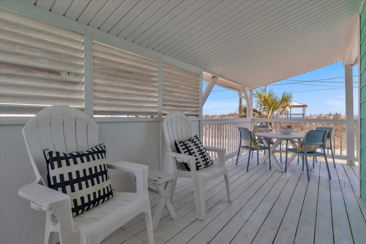 Your private covered deck awaits with comfortable seating and dining space, perfect for morning coffee or sunset cocktails.