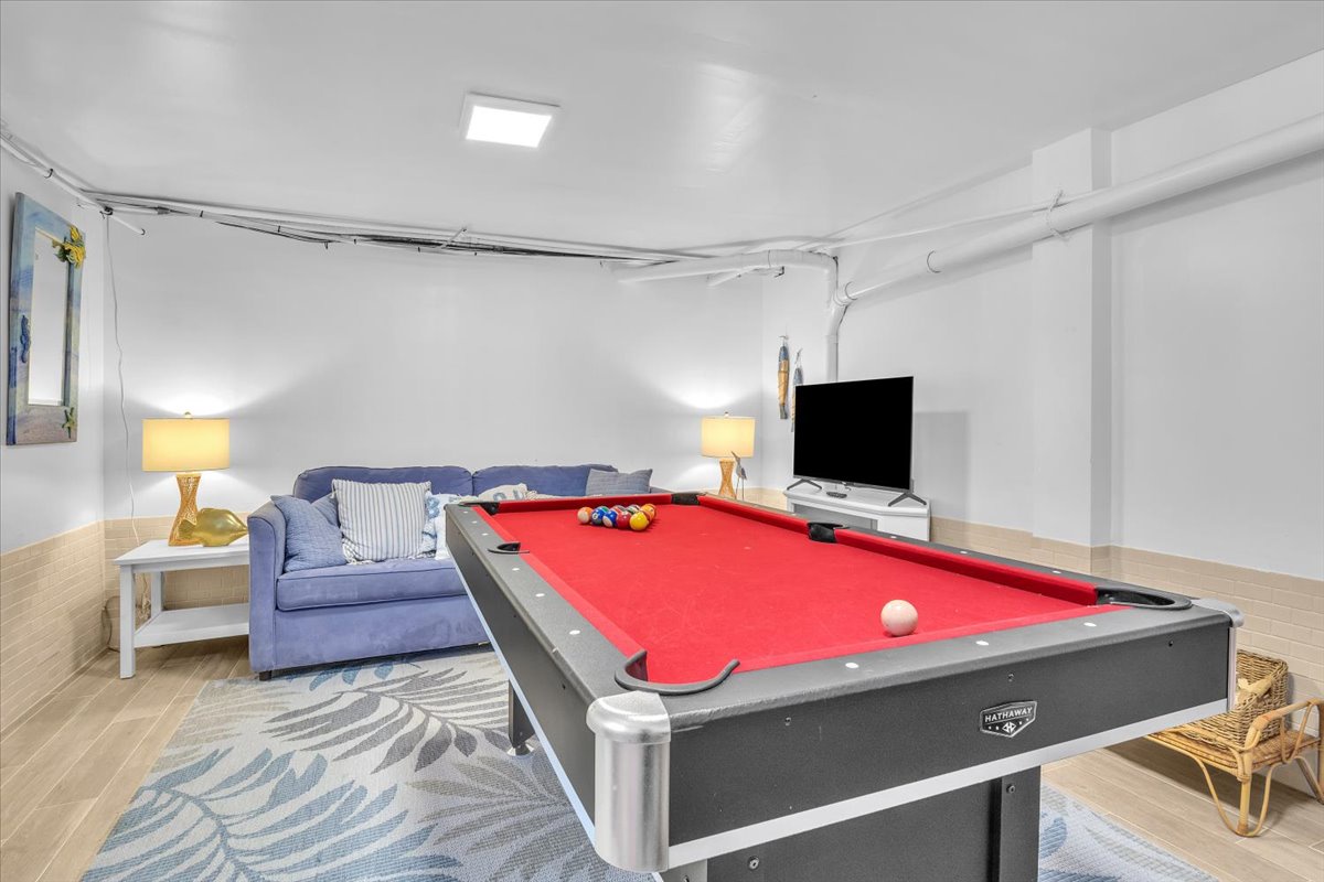 Challenge friends to a game on your private pool table, then unwind on the cozy sectional sofa in this bright entertainment space.