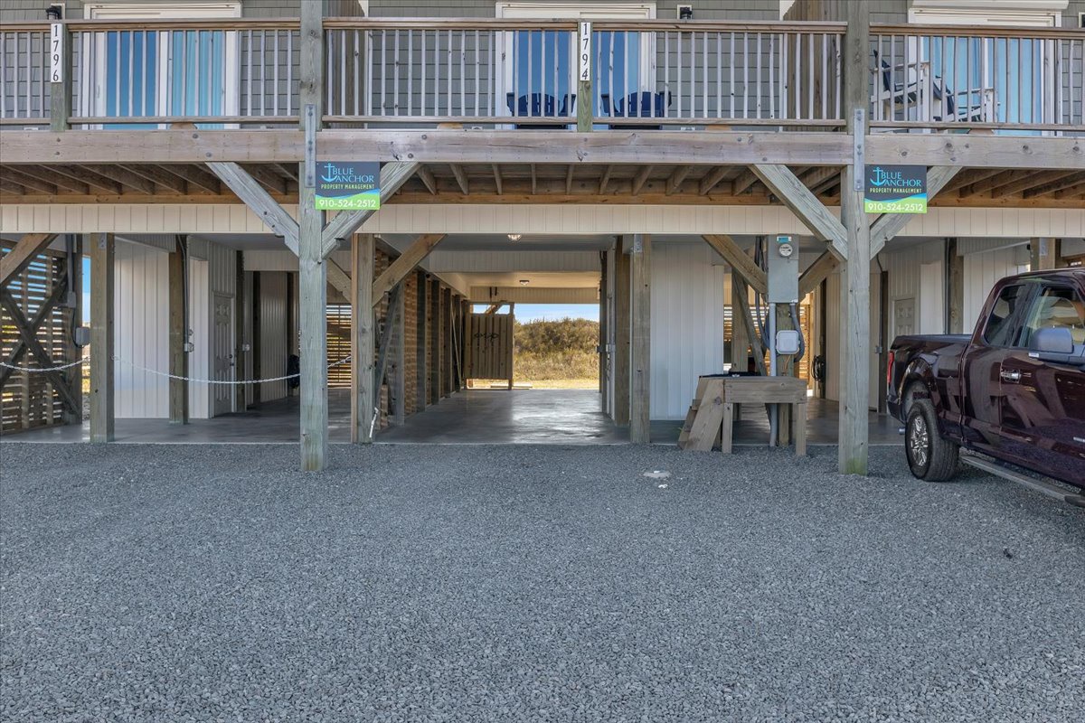 Your vehicle stays secure in the covered ground-level parking area beneath your beachside retreat.
