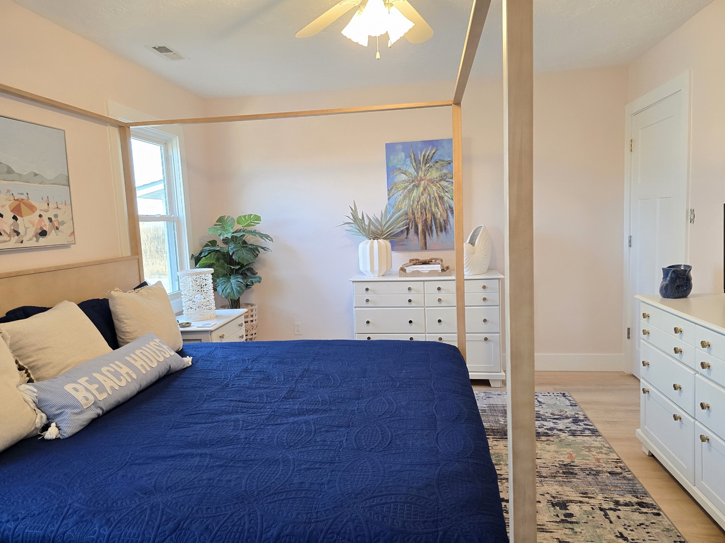 Sink into your luxurious four-poster bed surrounded by coastal-inspired artwork and ample storage for your belongings.