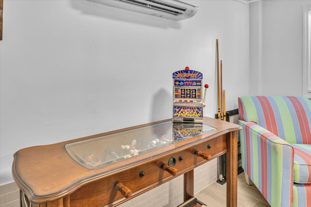 Your private game room awaits with vintage arcade fun, pool table action, and colorful seating for hours of entertainment.