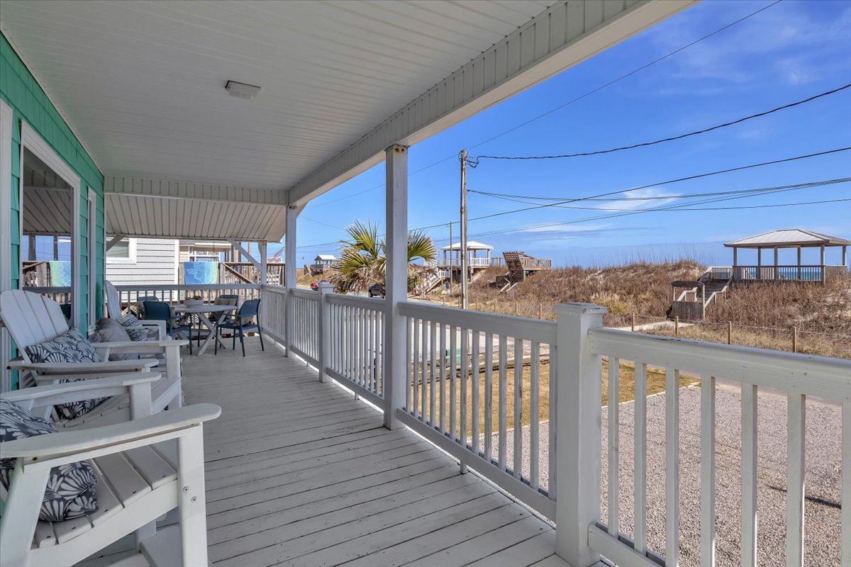 Relax on your private covered porch with comfortable seating and coastal views, perfect for morning coffee or evening sunsets.