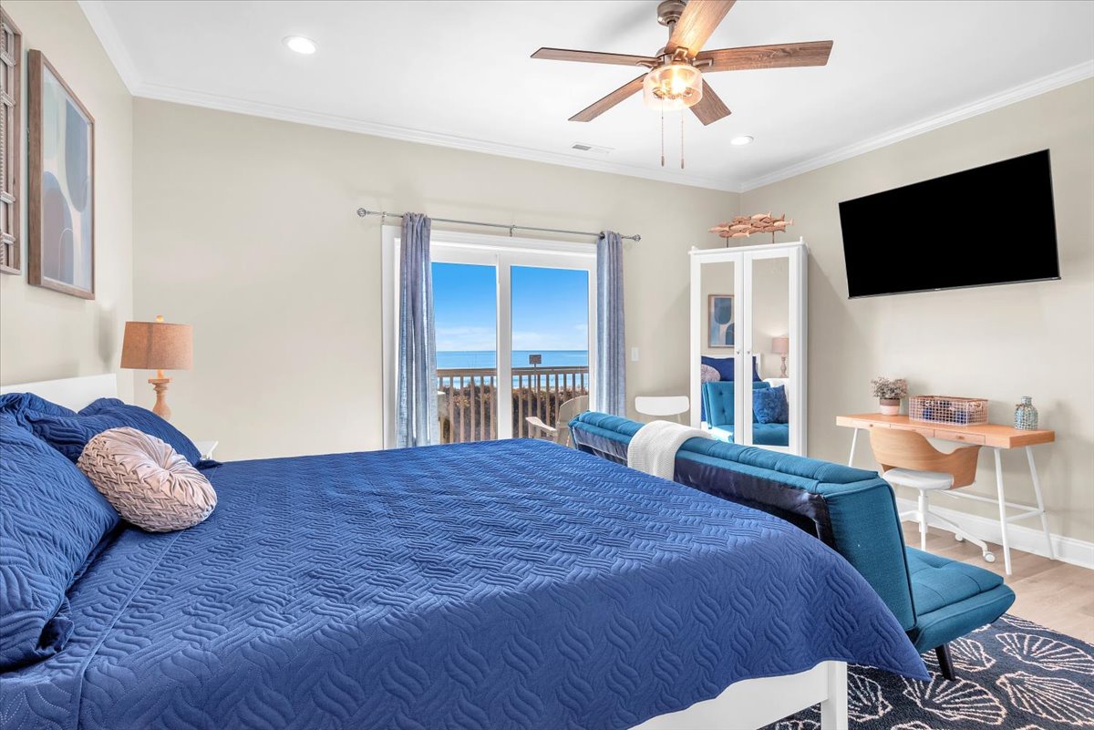 Wake up to stunning ocean views in your coastal bedroom, where blue linens echo the sea outside your balcony doors.