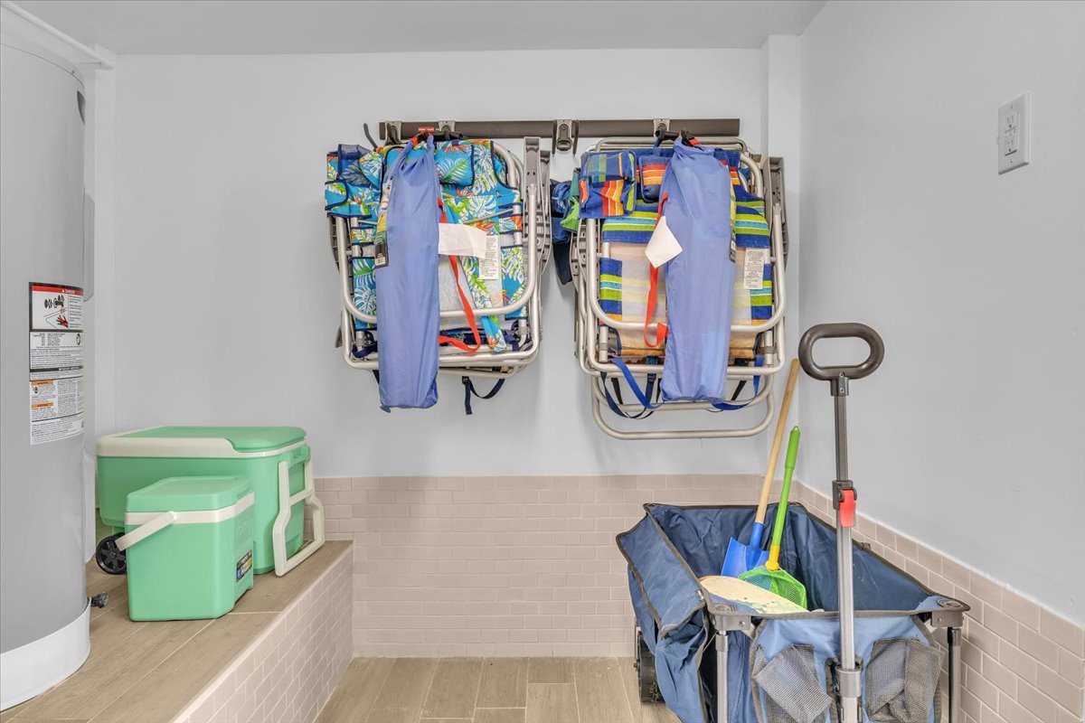 Store your beach gear and belongings in this convenient storage room with wall-mounted organizers and coolers for your seaside adventures.