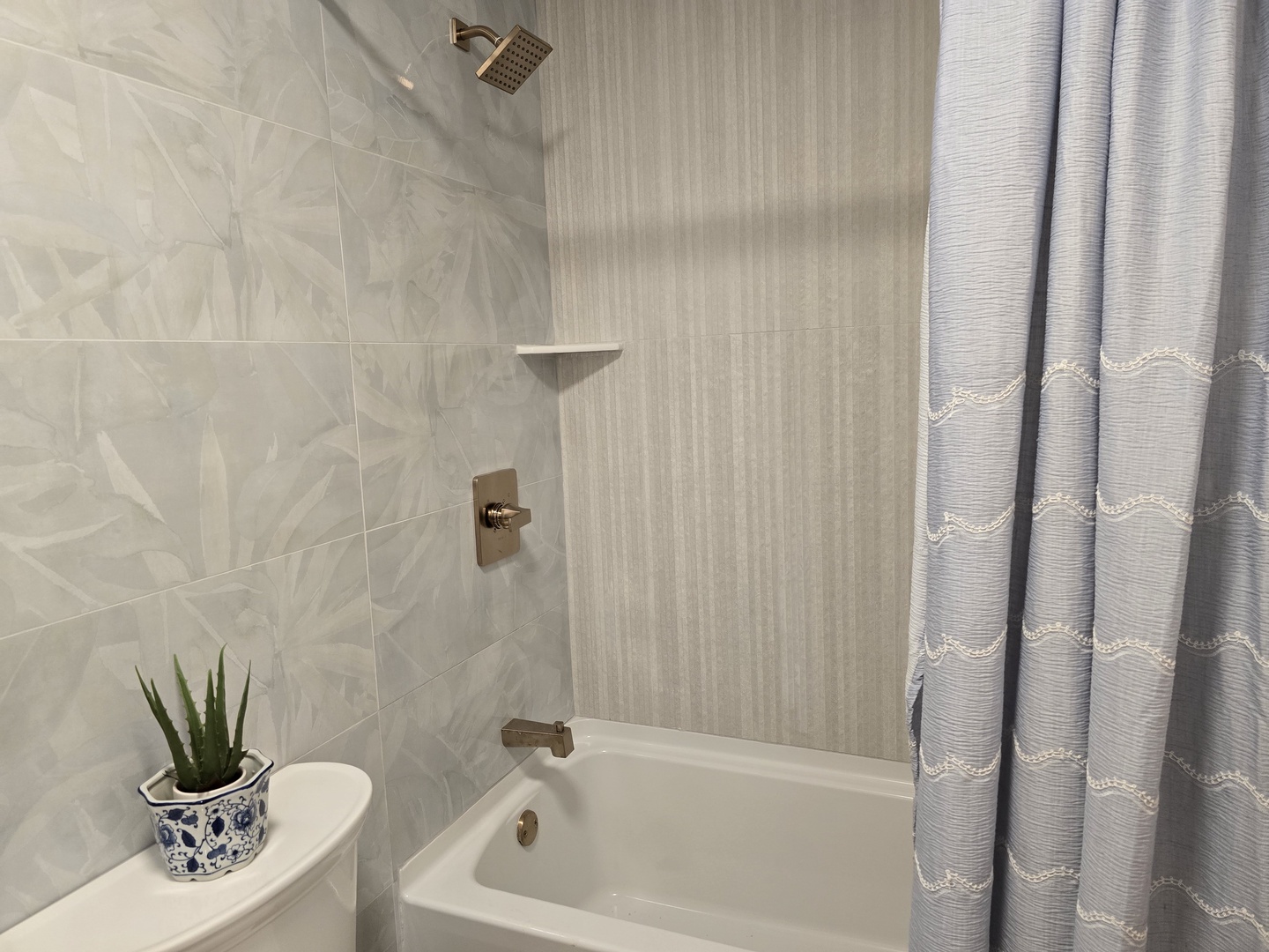Step into your elegant bathroom where modern marble-look tiles and sleek fixtures create a spa-like retreat for your daily relaxation.