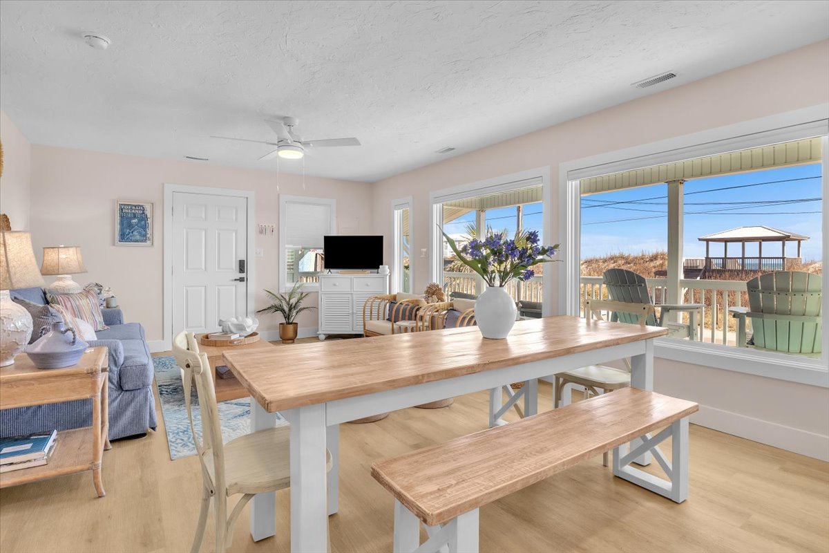 Gather around your farmhouse-style dining table while natural light streams through large windows, creating the perfect spot for morning coffee and evening meals.