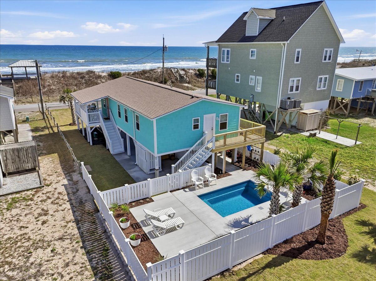 Charming beachside retreat featuring a private pool, deck space, and direct ocean access just steps from your door.