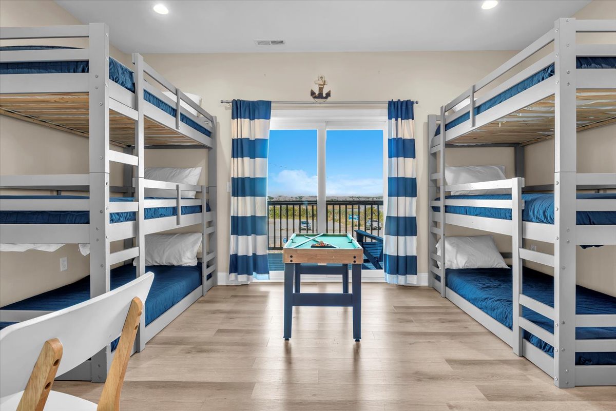 Your group will love this nautical bunk room with four cozy beds and stunning views through the sliding doors.