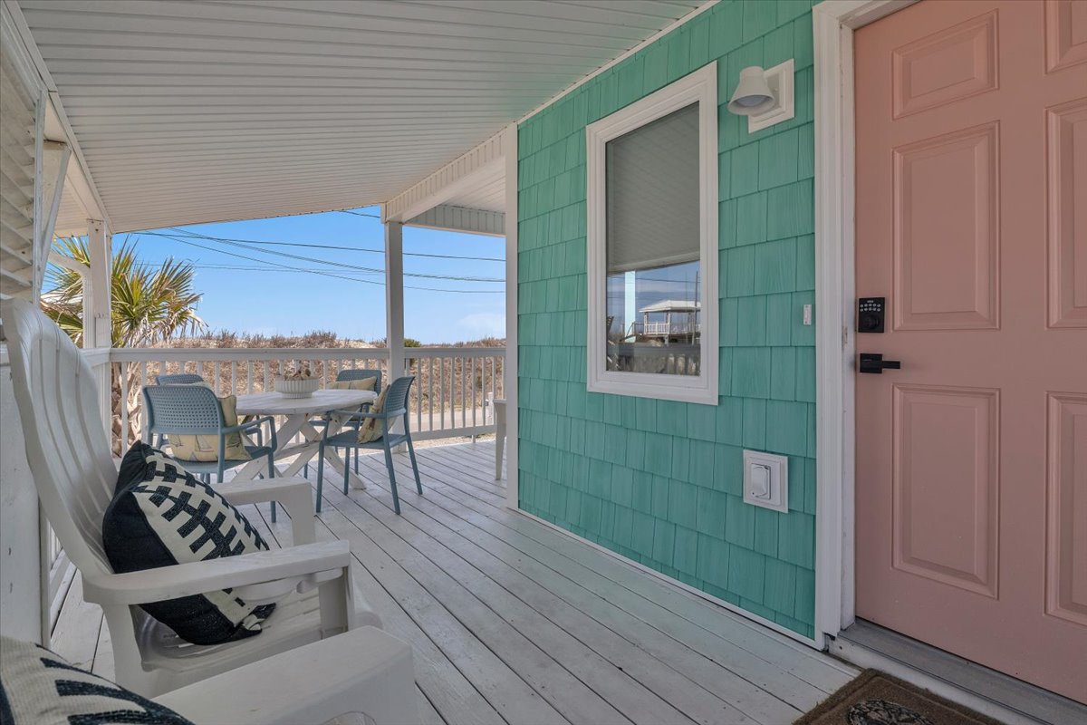 Step onto your private deck where coastal breezes meet comfortable seating and outdoor dining awaits under the covered porch.