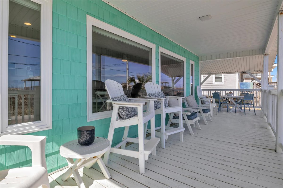 Your covered porch offers the perfect coastal retreat with white Adirondack chairs where you can relax and soak in ocean breezes.