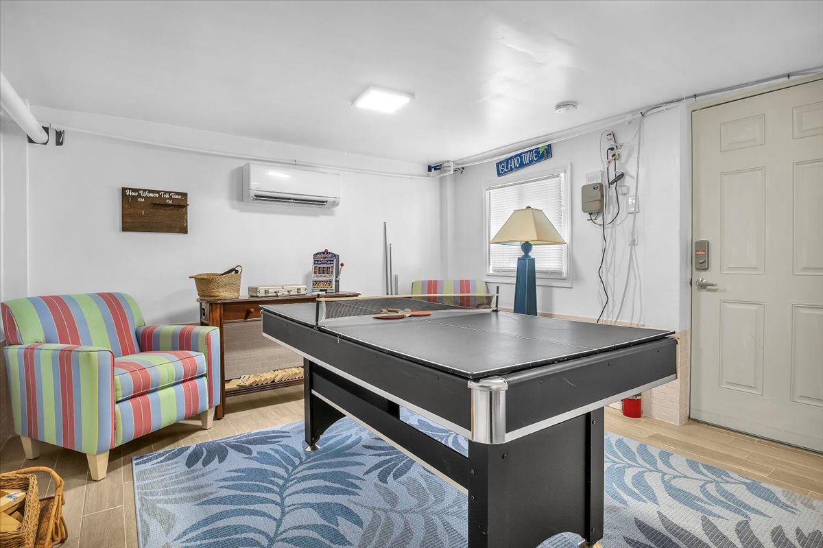 Your game room awaits with billiards, colorful seating, and air conditioning for perfect indoor entertainment.