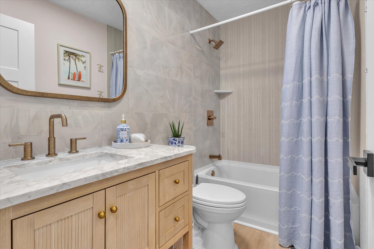 Your elegant bathroom features marble counters, warm brass fixtures, and a relaxing tub-shower combo for unwinding after your adventures.