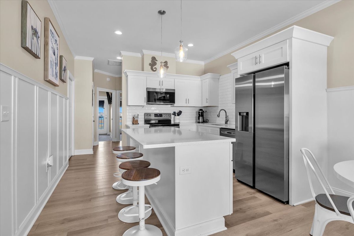Your bright, modern kitchen awaits with white cabinets, quartz counters, and stainless appliances for memorable meal prep.