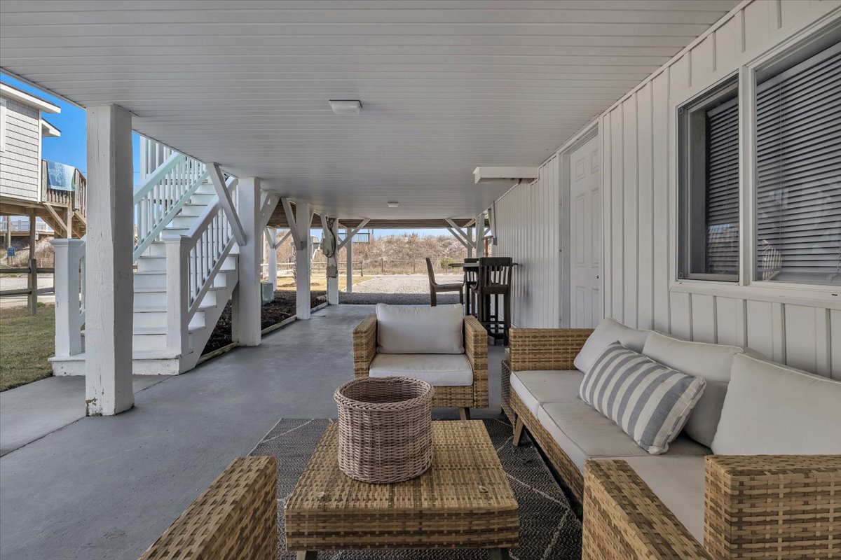 Unwind in your private outdoor lounge with plush wicker seating and serene lake views—perfect for morning coffee or evening relaxation.
