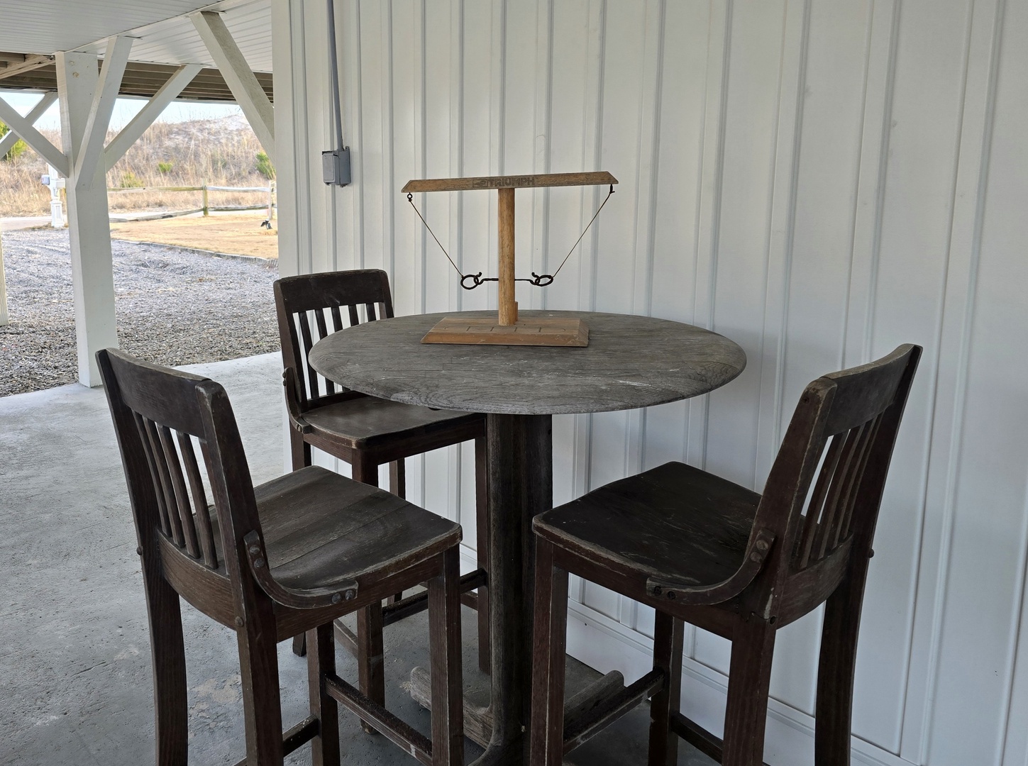 Your outdoor dining space awaits with a cozy table for four under the covered patio, perfect for morning coffee or evening conversations.