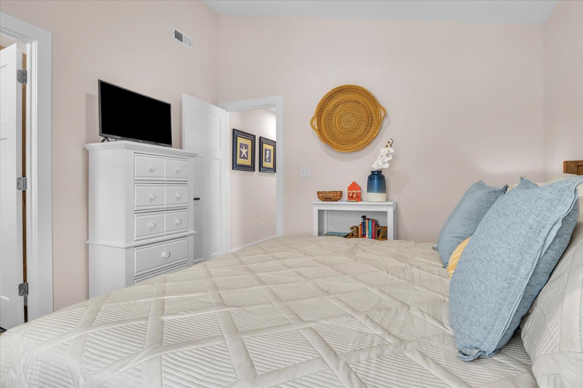 Drift into peaceful sleep in your cozy bedroom, complete with soft linens, entertainment, and thoughtful coastal touches.