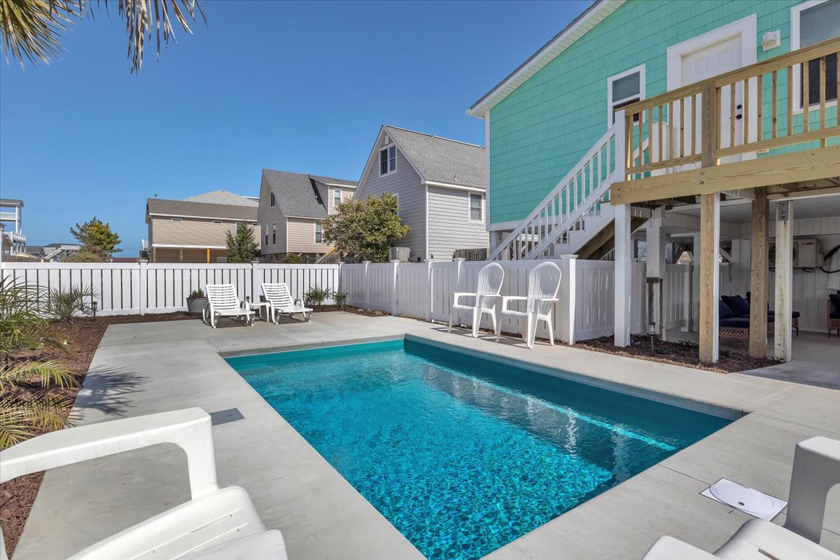 Dive into your private oasis with crystal-clear waters and sunny poolside lounging. Your coastal retreat awaits with turquoise comfort steps away.