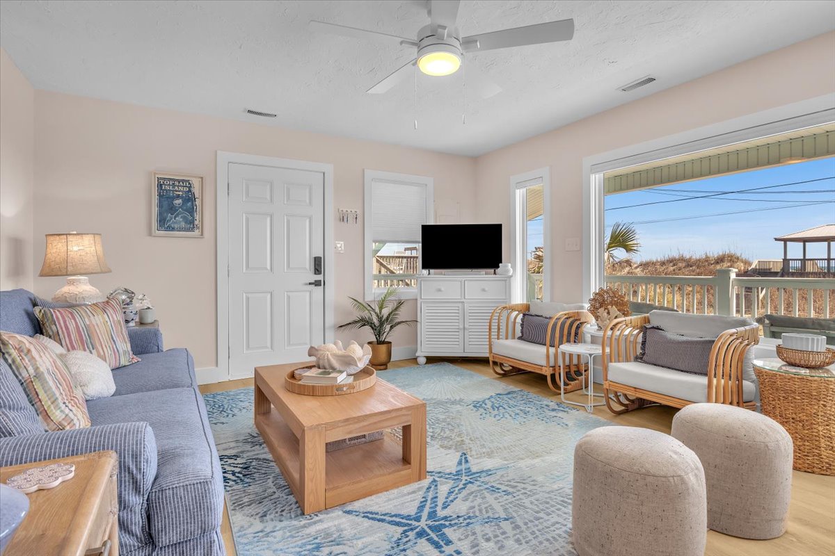 Unwind in your coastal living room with ocean breezes from the ceiling fan and stunning water views through large windows.