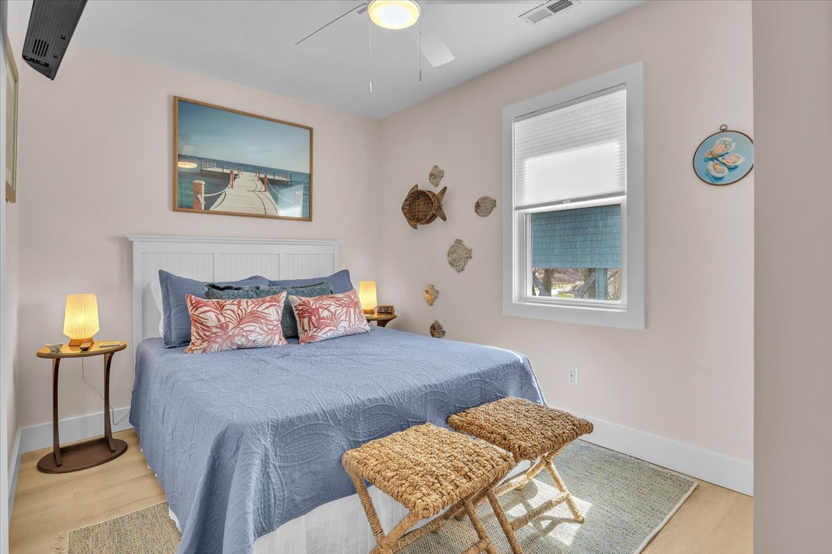 Sink into coastal comfort in your serene bedroom, where soft blue linens and warm nautical touches create the perfect retreat for peaceful nights.