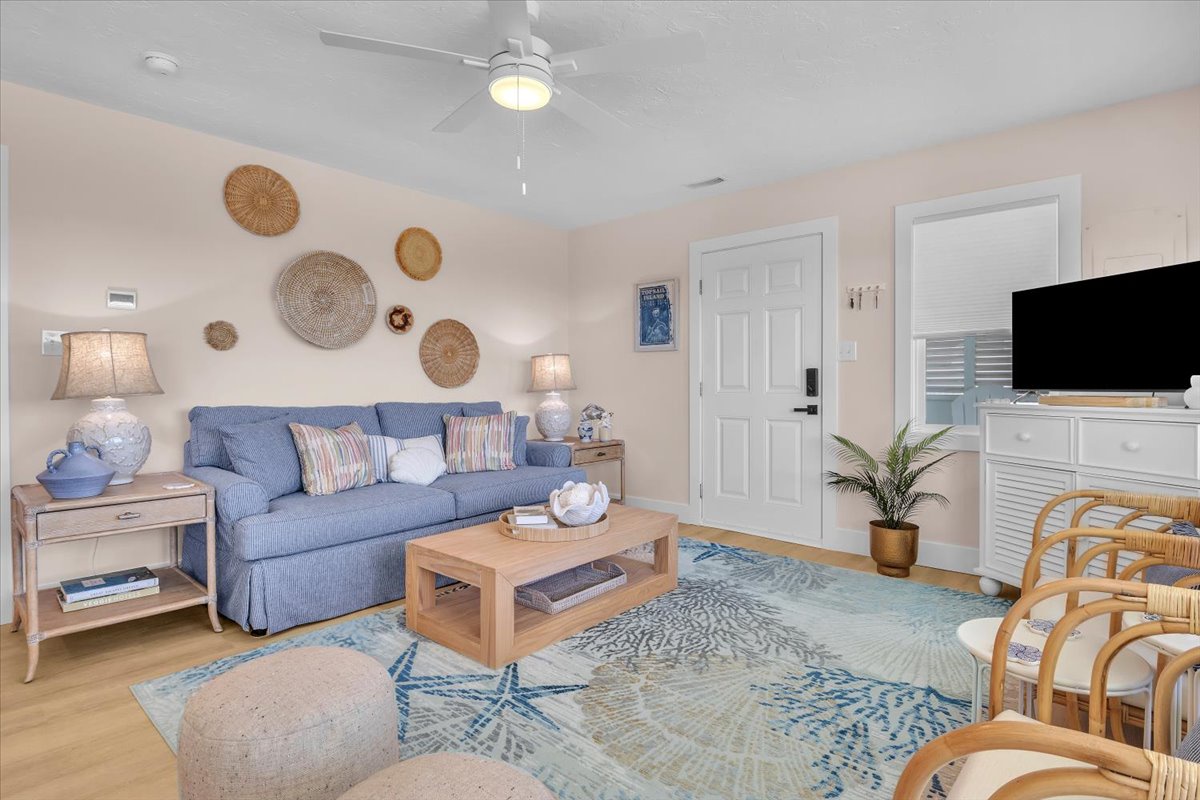 Unwind in your coastal-inspired living room with soft blue tones, natural textures, and modern amenities that create the perfect vacation retreat.