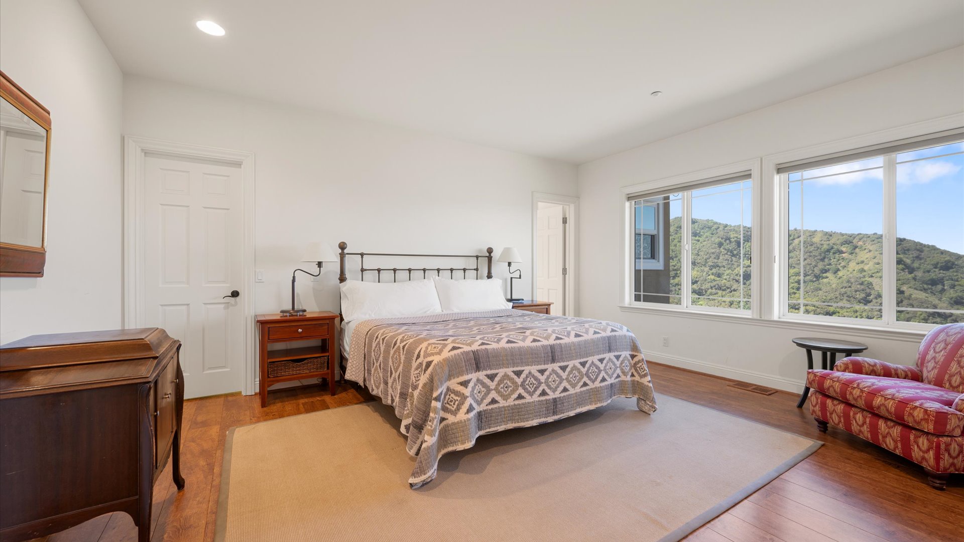 The south primary bedroom also features natural lighting and sweeping views