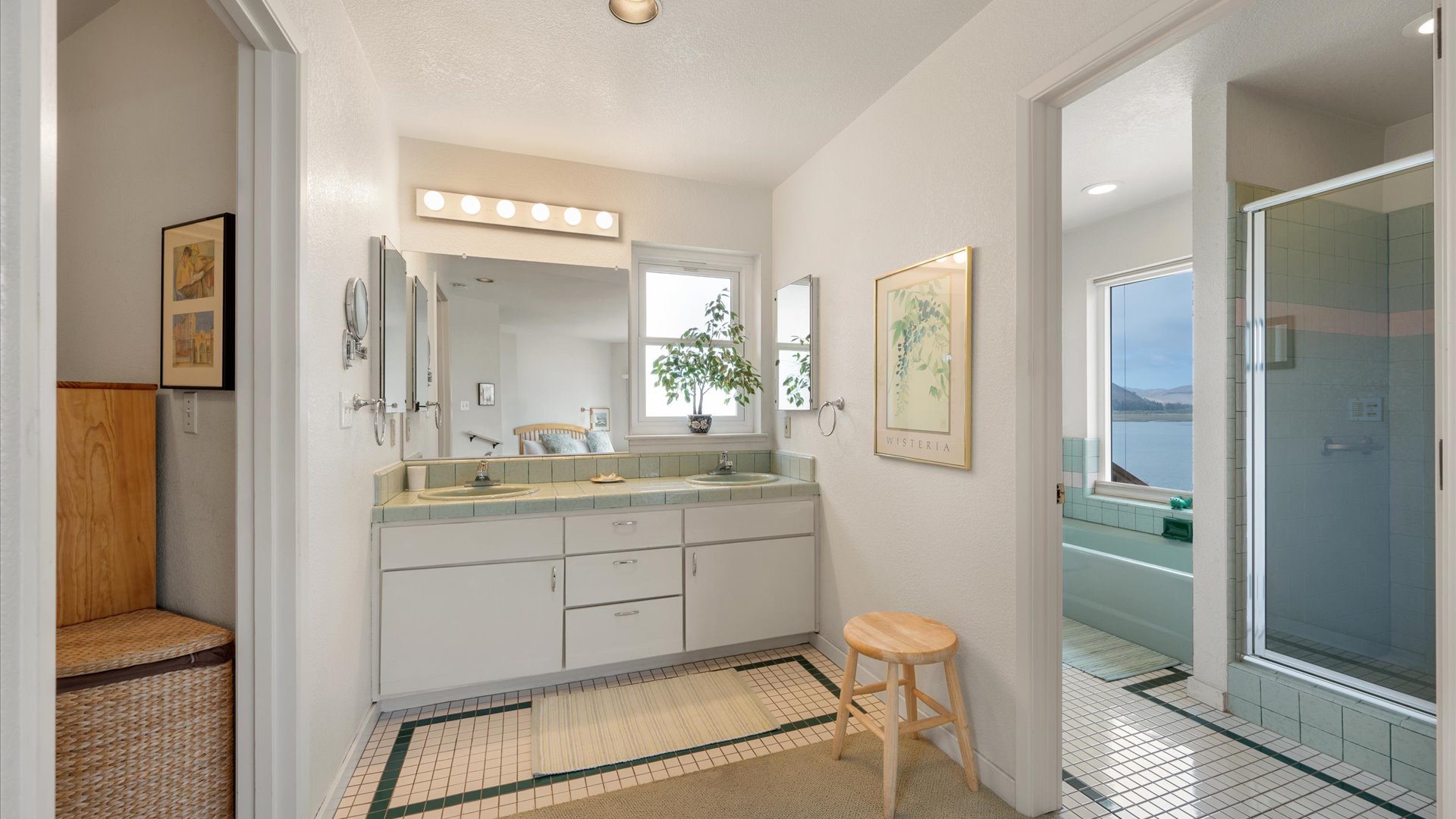 En suite master bath with dual vanity, step in shower, and seperate soaking tub