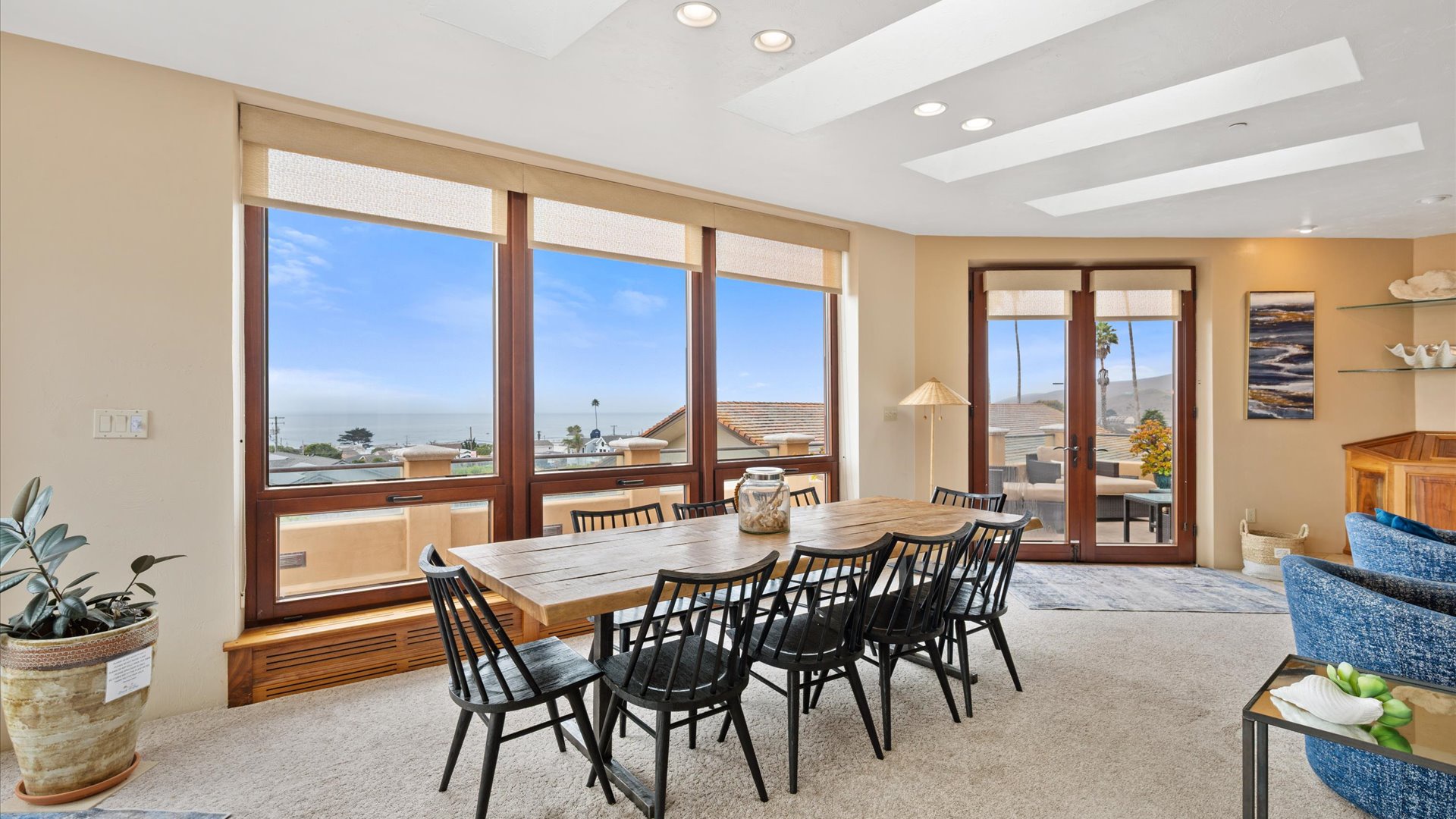 Gather around this inviting dining table with ocean views framing your meals.