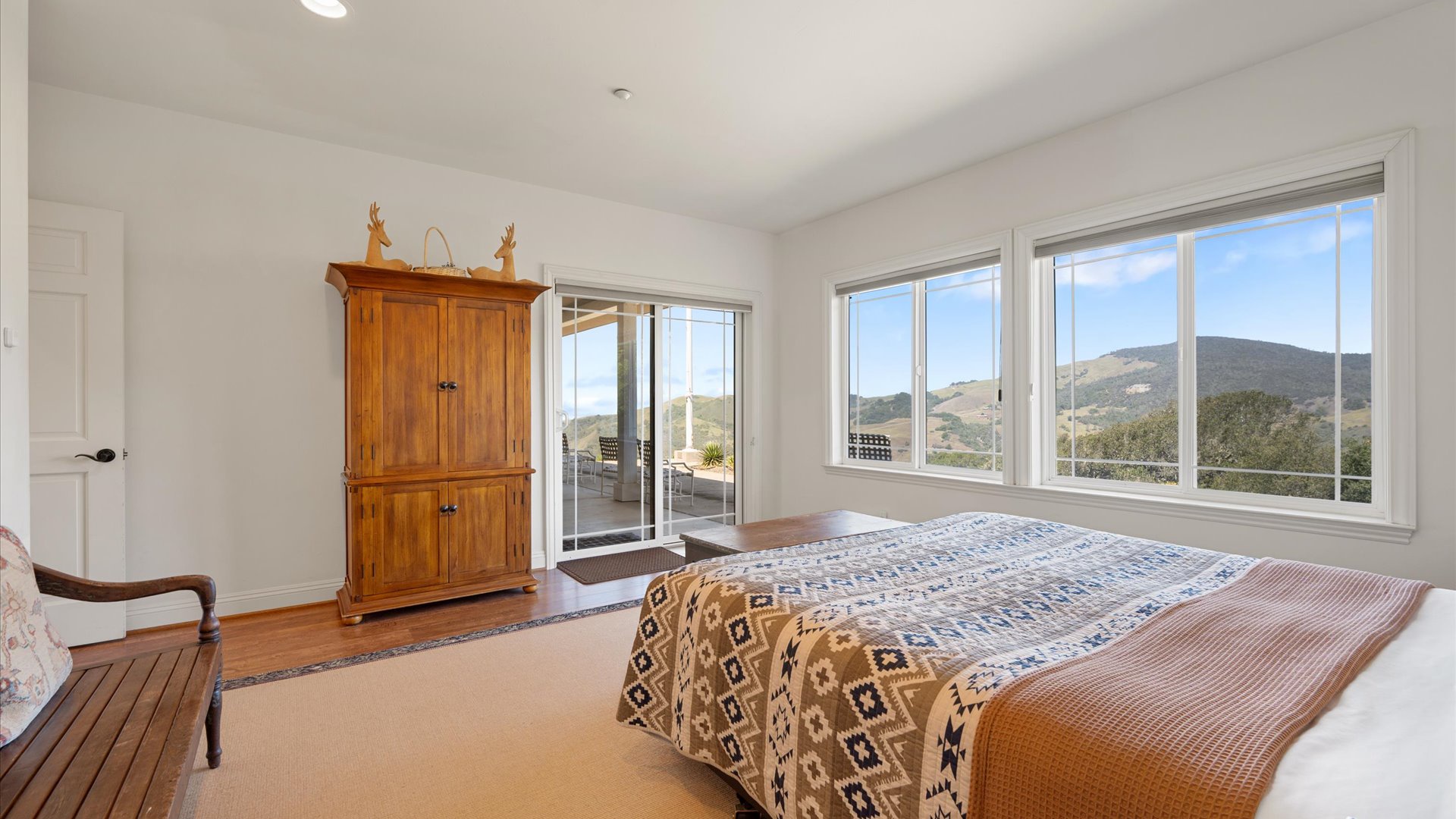 Wake up to sweeping  views streaming through the windows, where the patio awaits just beyond those sliding doors.