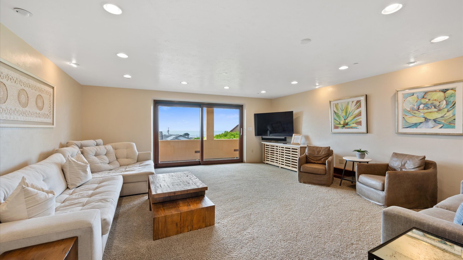 Bonus room serves as a second living room with cozy seating, large flat screen TV, wrap-around balcony access and a queen-size fold out sofa bed