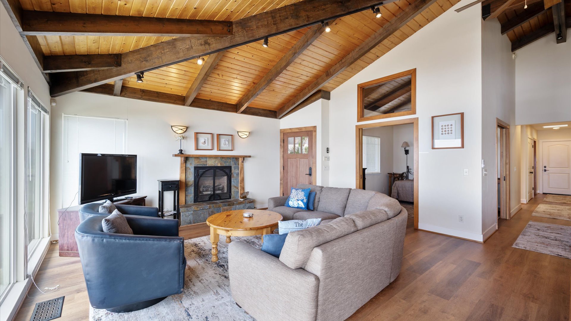 The living room is central to the home, with bedrooms down the hallway