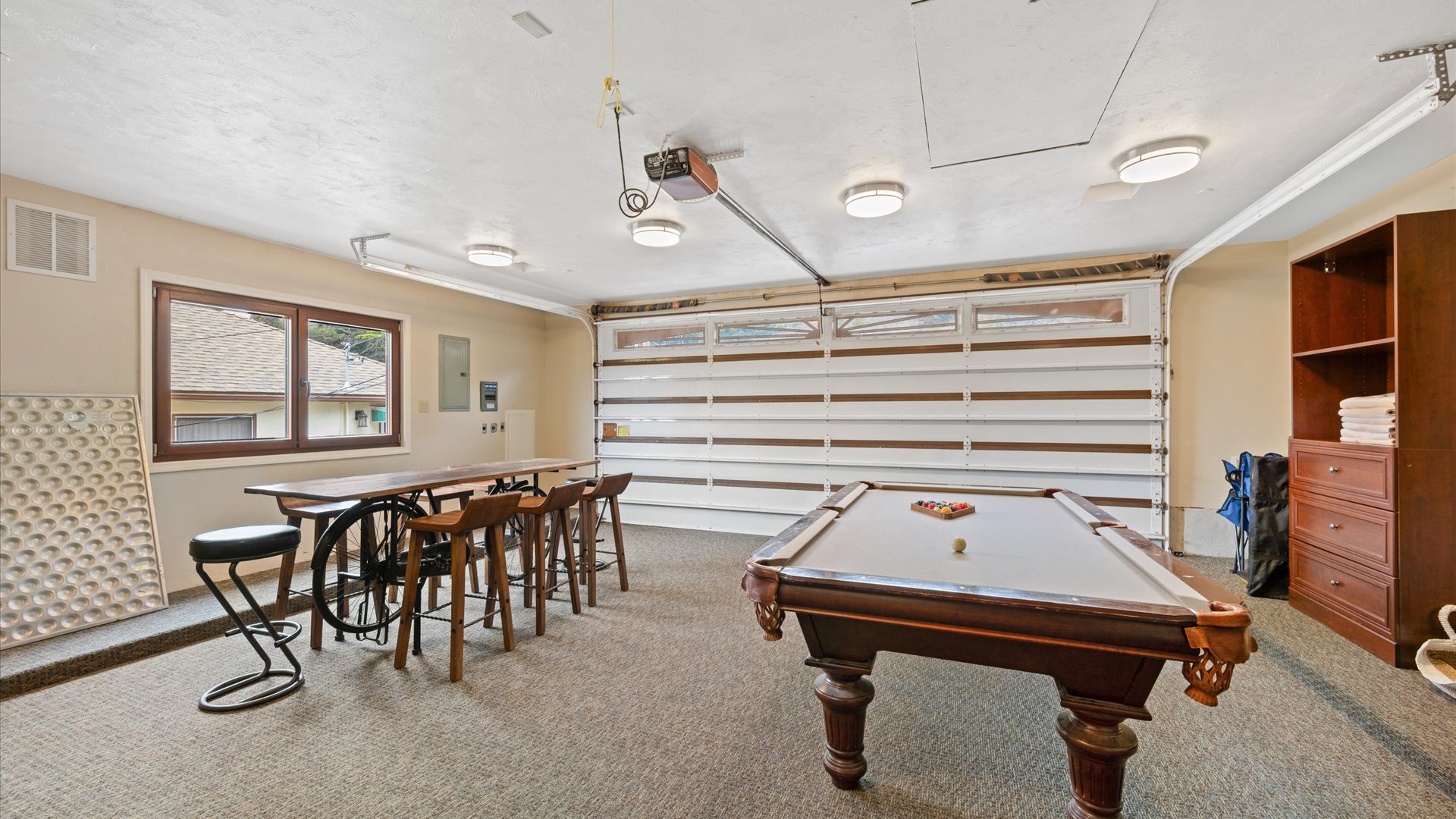 The Garage Game Room includes a pool table with convertible ping pong table top and a dining set to seat 8