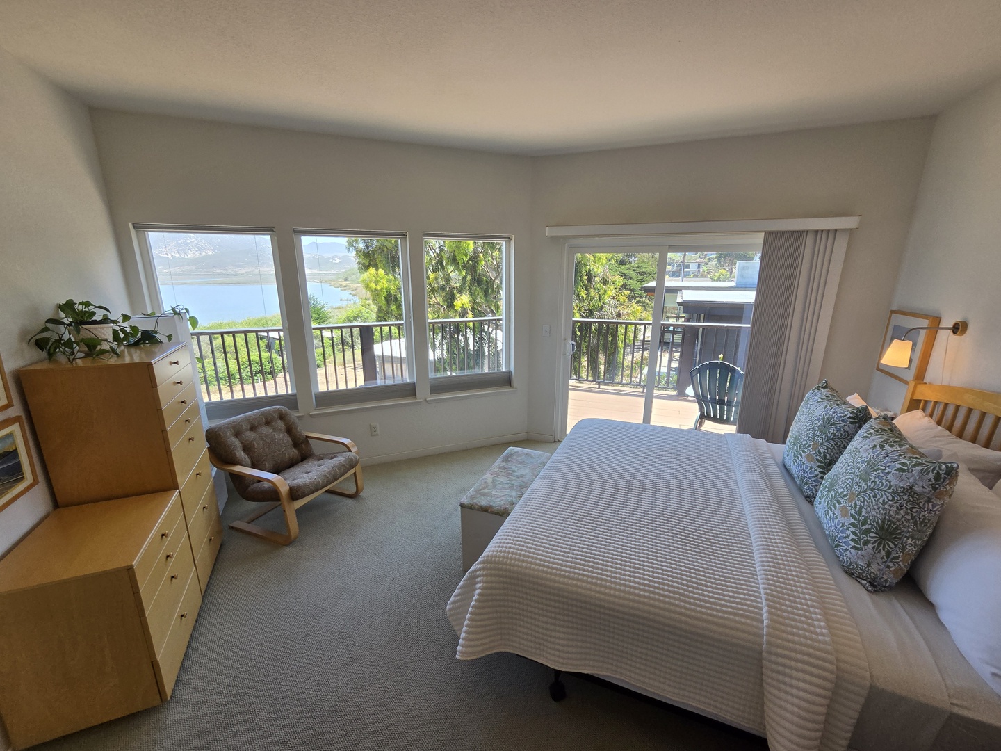 Second bedroom offers a queen-sized bed, flat screen tv, and access to the deck with bay views