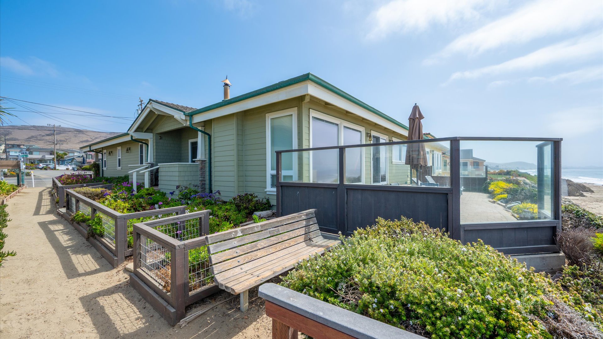 As you approach the house from the beach, you will enjoy the beautiful landscaping that surrounds the home.