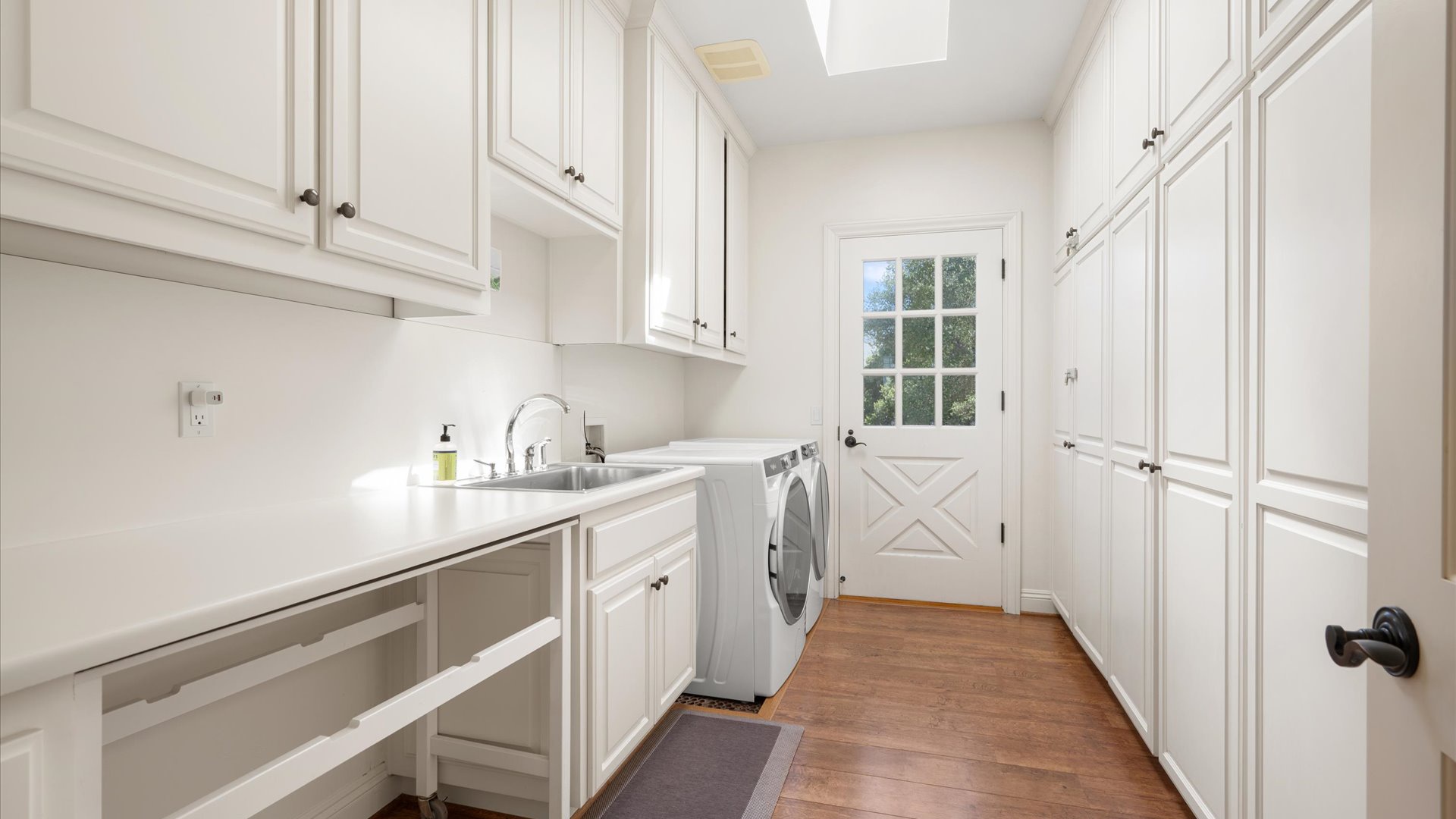 Spacious and convenient laundry room with high capacity washer  dryer