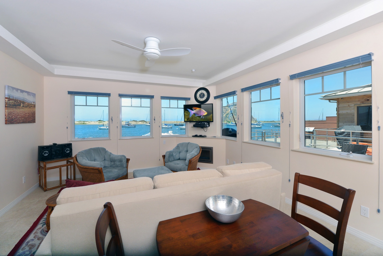 This comfy living room has large TV, fireplace and never ending views.