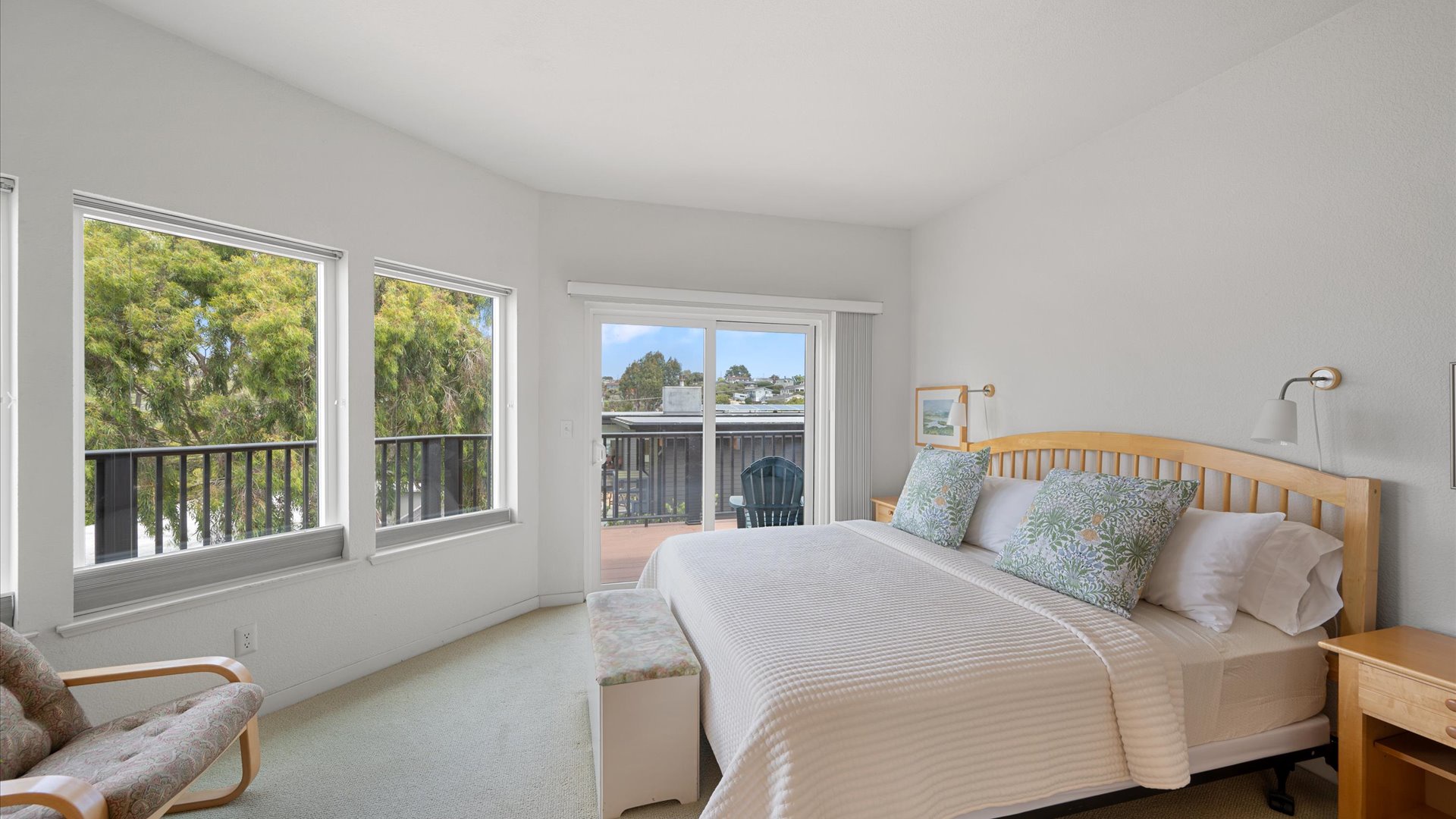 Primary suite offers a king-sized bed and access to the deck with bay views