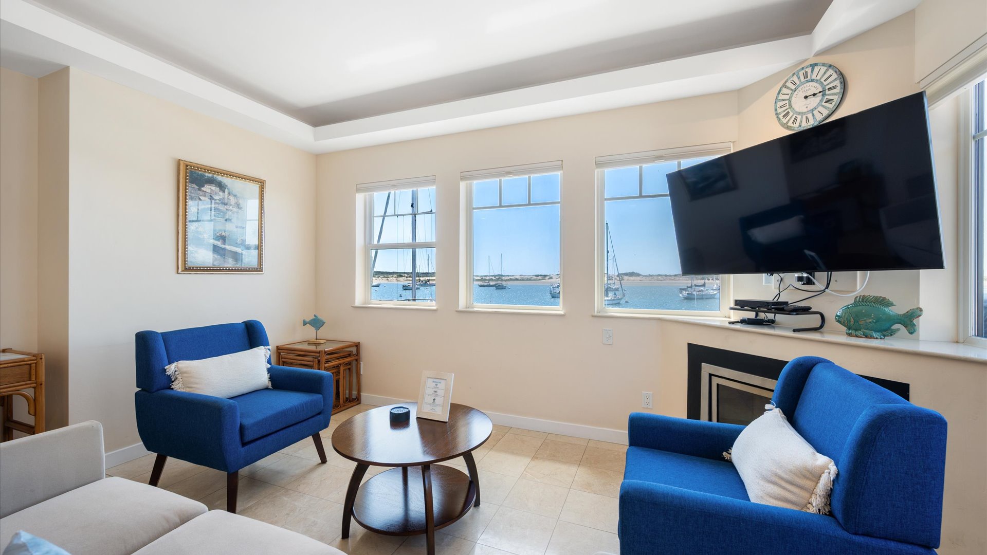 This comfy living room has large TV, fireplace and never ending views.