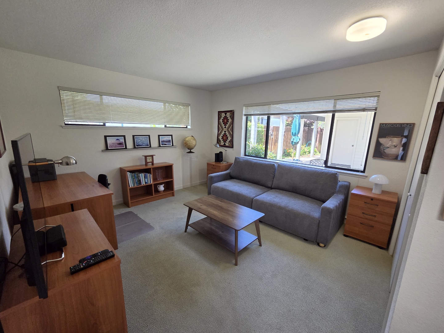 3rd Bedroom/Den features a Serta Gabi convertible sleeper sofa that transforms into a queen bed or one/two lounge chairs, a desk, and flat screen tv.