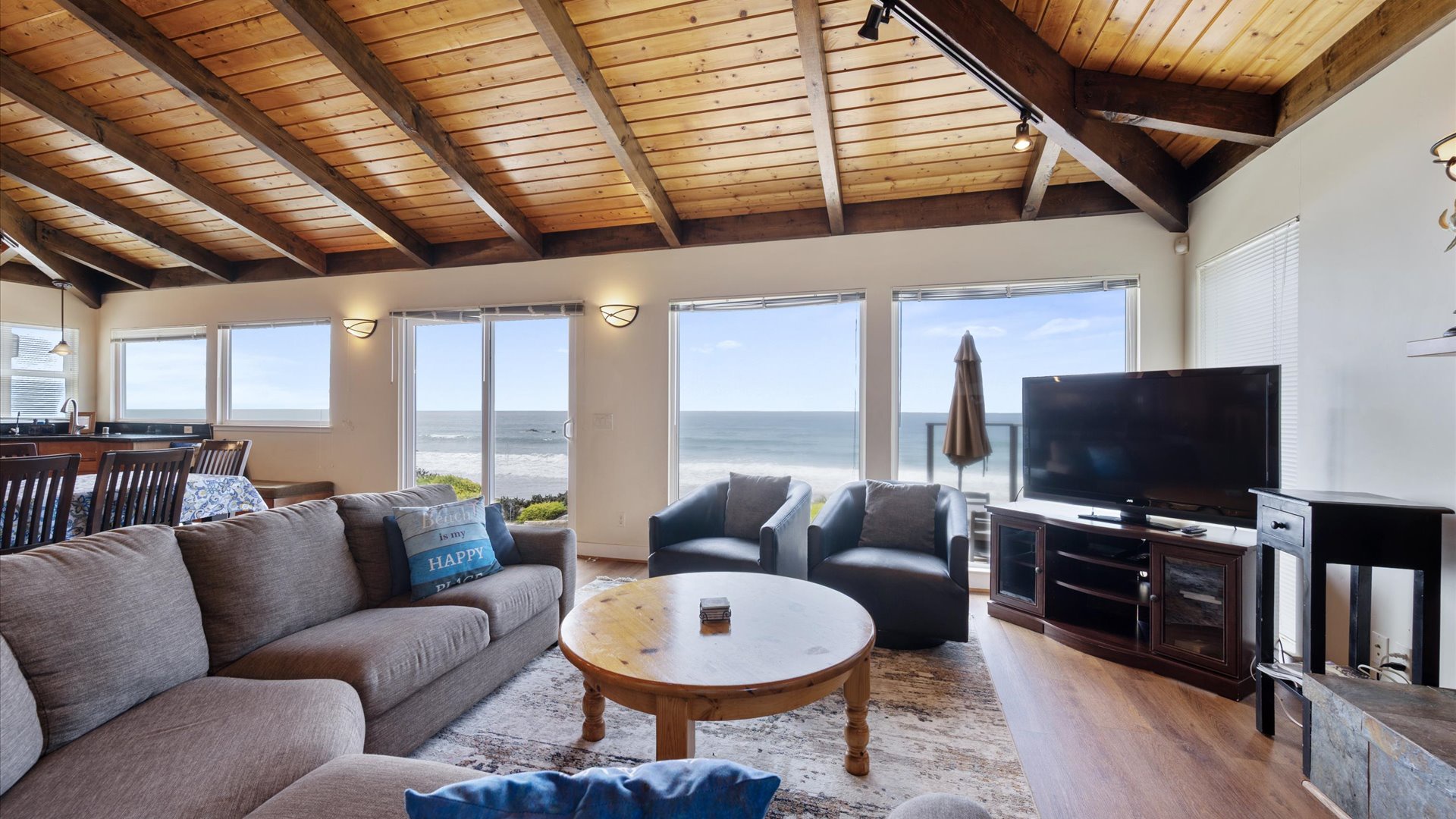 The living room offers comfortable furniture, a cozy fireplace and amazing views