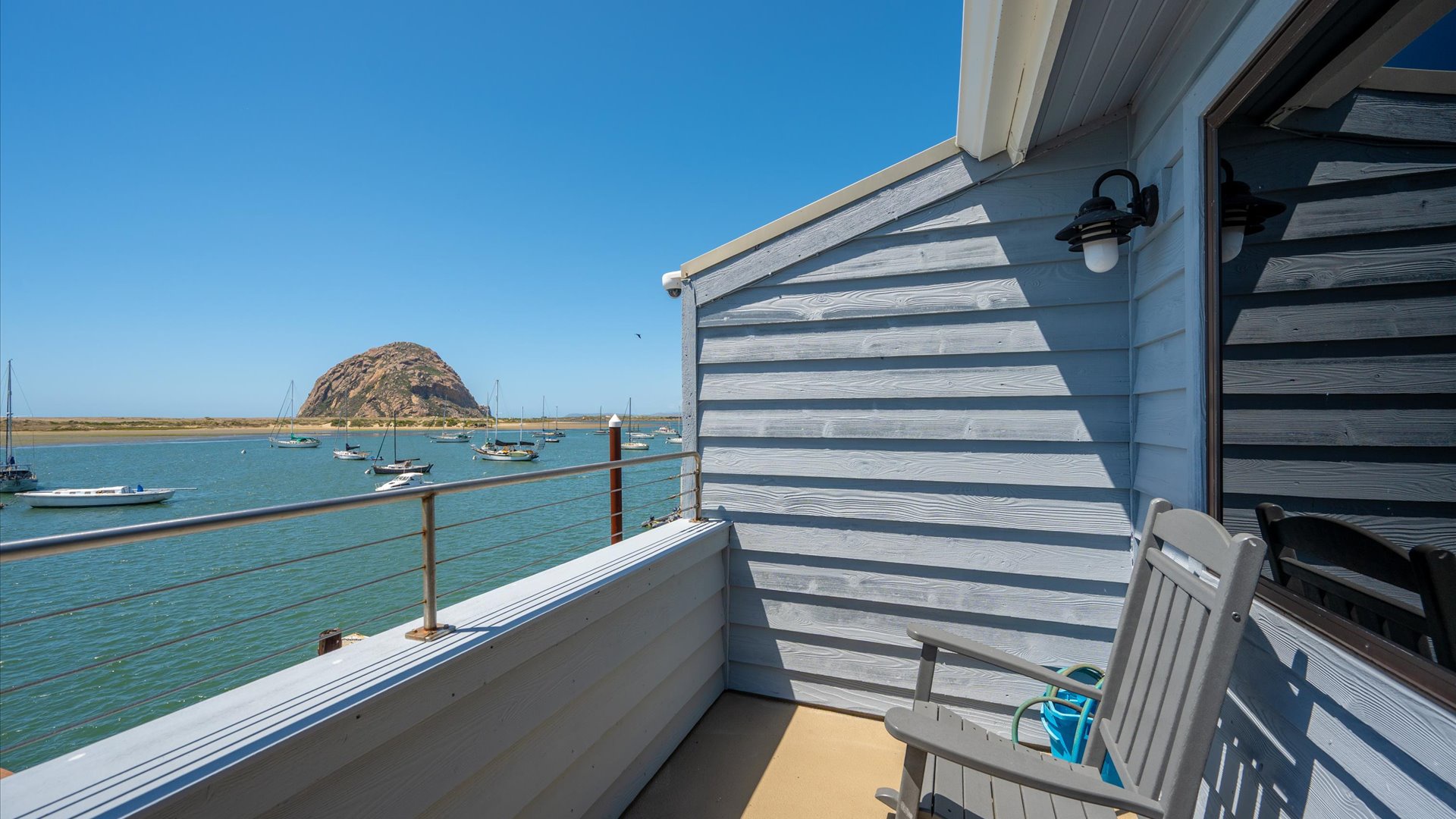 From the balcony, you look across the bay to amazing views of the rock.  The balcony includes a Weber grill and comfortable seating.