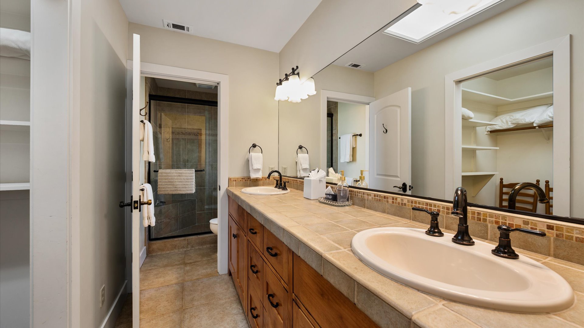 Master bathroom offers double sinks, a walk in closet, and shower