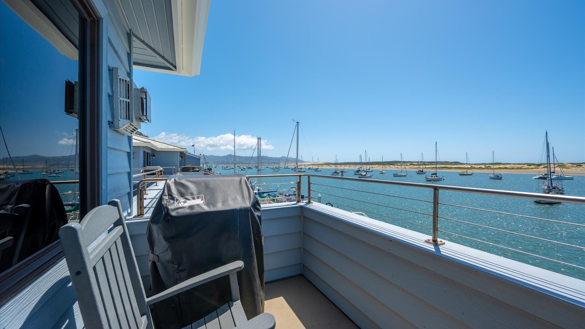 The balcony has a weber BBQ grill and 2 comfortable rocking chairs.