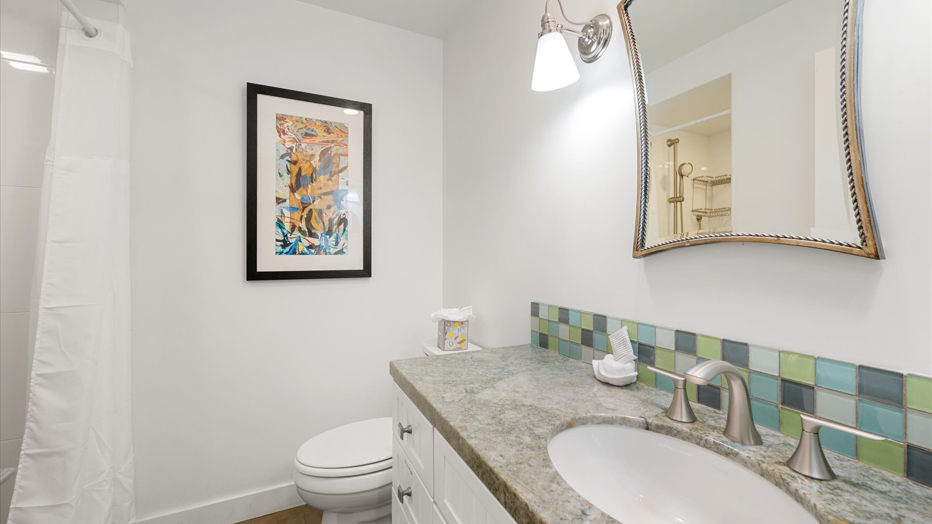 The full bathroom has a step in shower.