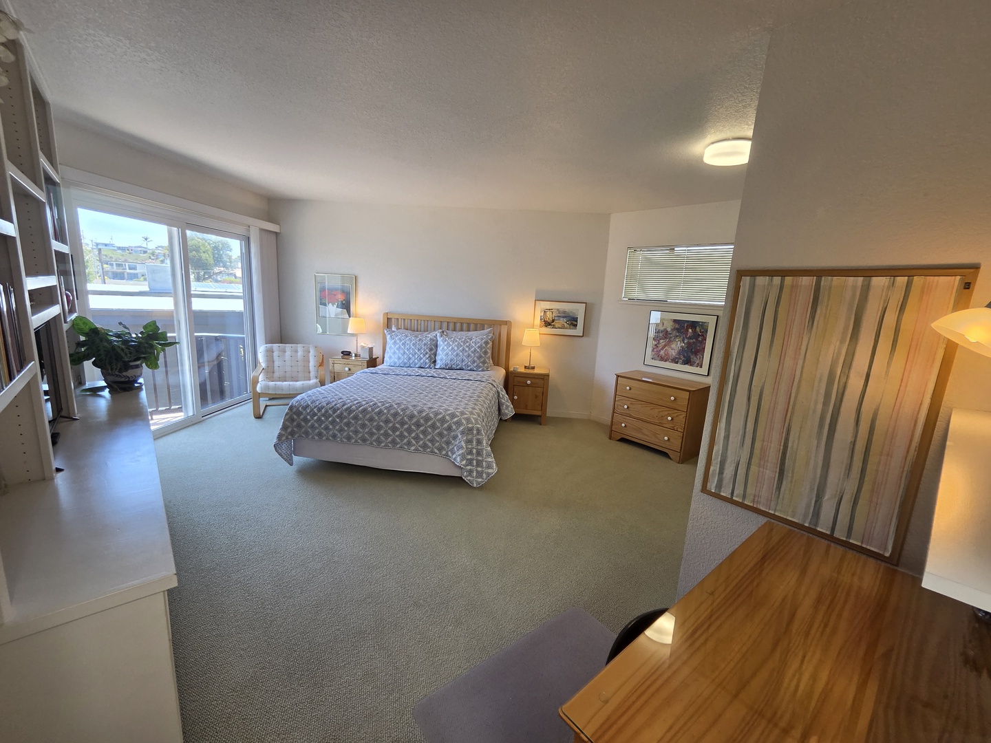 Primary Suite is spacious featuring a King-sized bed, access to the deck, and ensuite bath